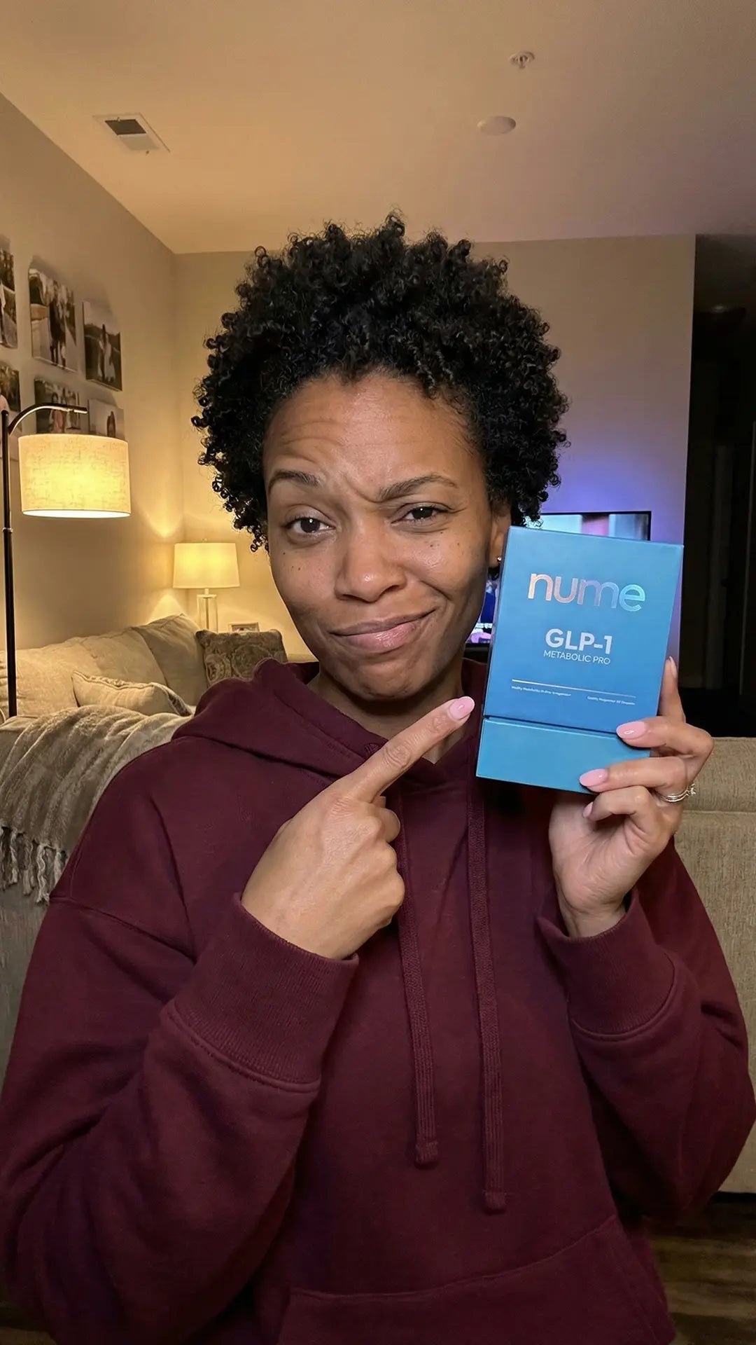 Customer pointing at Nume GLP-1 Metabolic Pro box in living room